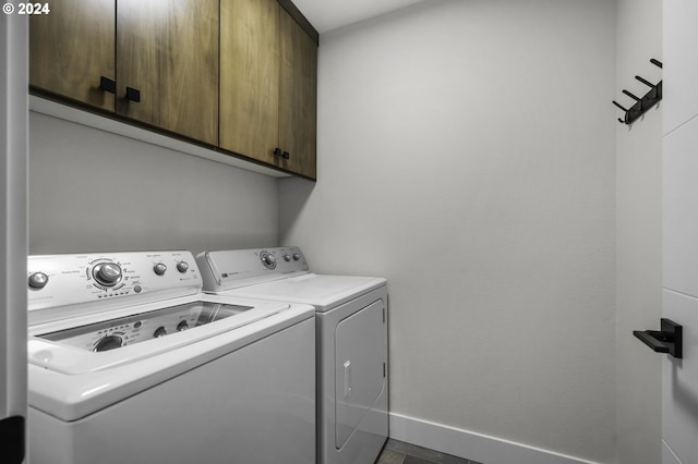 laundry area with cabinets and washing machine and dryer