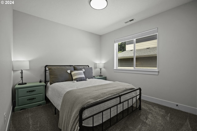 bedroom featuring dark carpet