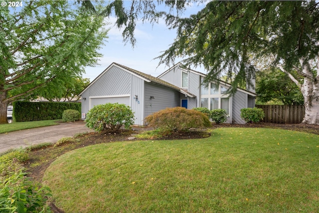 view of front of home featuring a garage and a front yard