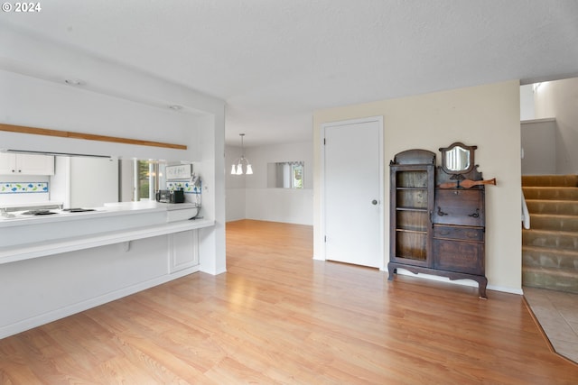 living room featuring light hardwood / wood-style floors and a notable chandelier