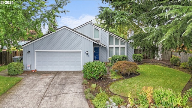 view of front of property with a garage and a front lawn