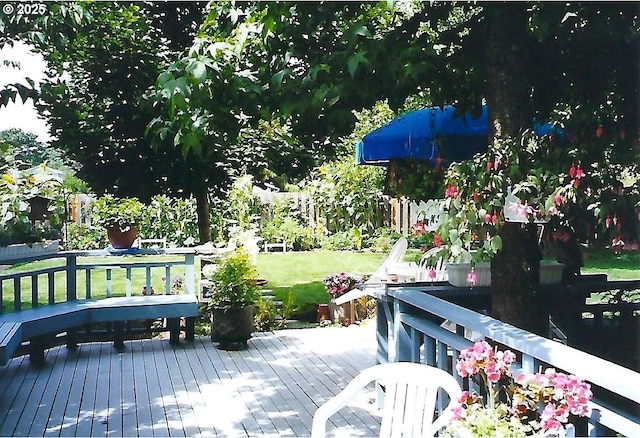 wooden terrace featuring a yard