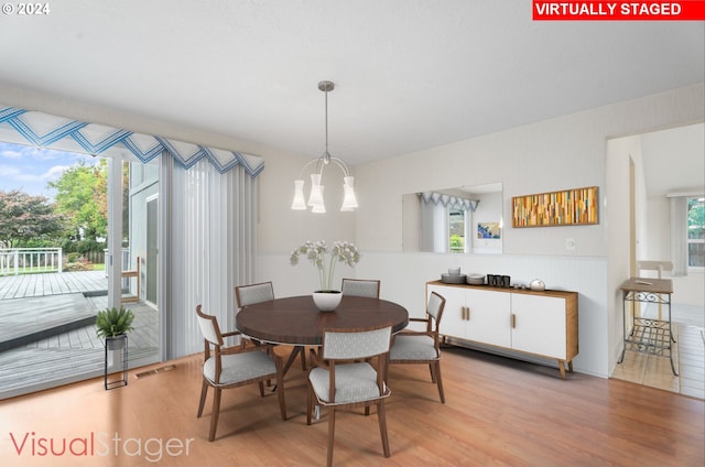 dining room featuring light hardwood / wood-style floors and an inviting chandelier