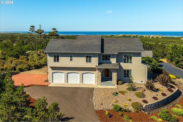 view of front of home with a water view and a garage