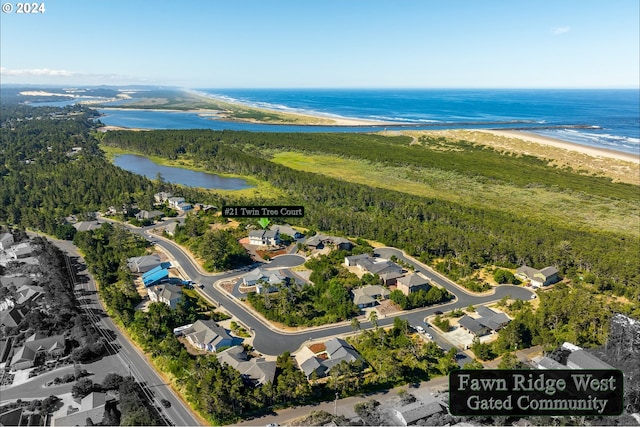 birds eye view of property with a water view and a view of the beach