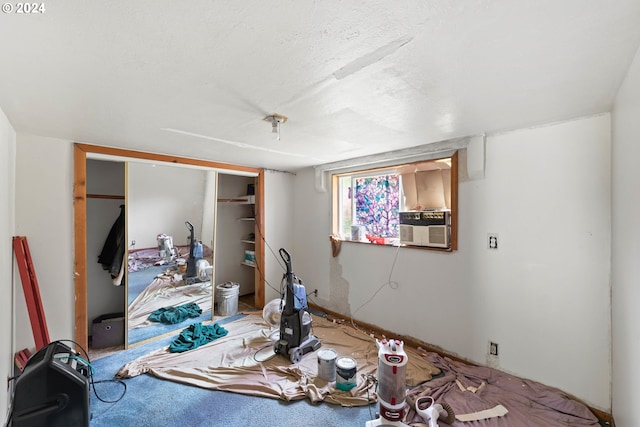 carpeted bedroom with a closet and cooling unit