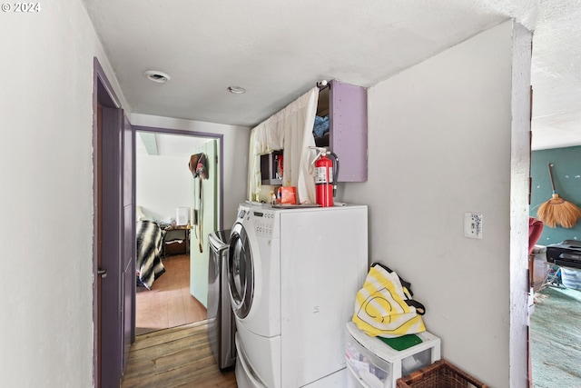 washroom with laundry area, washer / clothes dryer, and wood finished floors