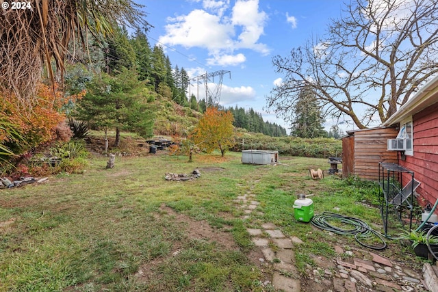 view of yard featuring cooling unit and a jacuzzi