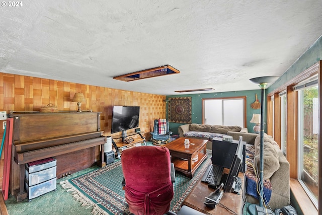 living area featuring carpet flooring and a textured ceiling