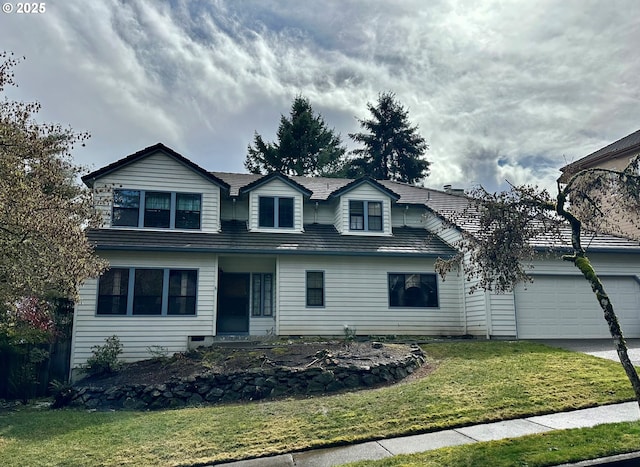 view of front of home with driveway, a front lawn, and an attached garage