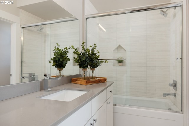 bathroom with vanity and combined bath / shower with glass door