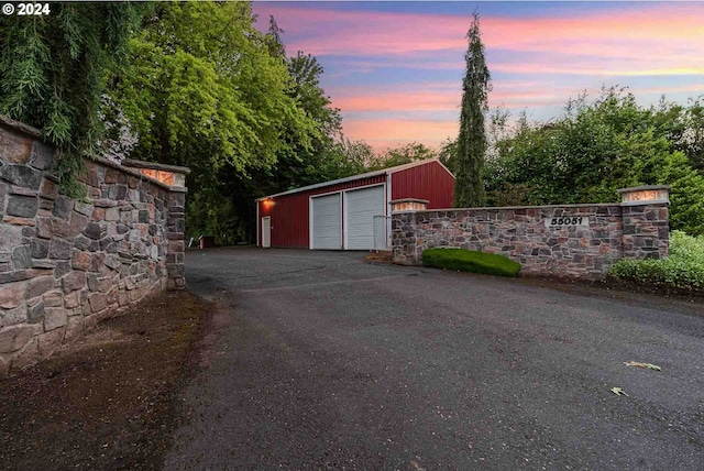 view of garage at dusk