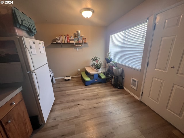 kitchen featuring light wood-type flooring and white fridge