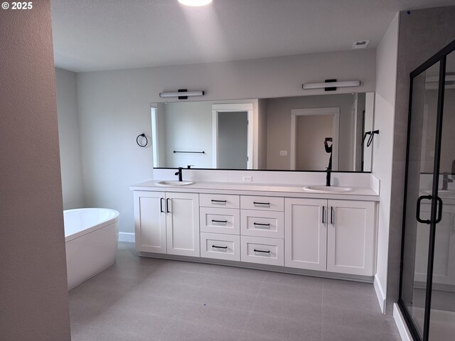 bathroom with vanity and shower with separate bathtub