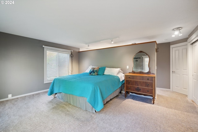 bedroom with light colored carpet