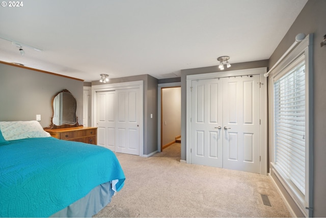 unfurnished bedroom with carpet flooring and multiple closets