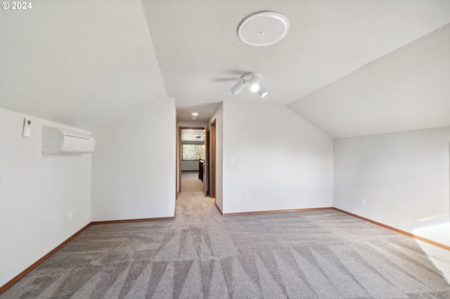 bonus room with ceiling fan, an AC wall unit, vaulted ceiling, and light colored carpet