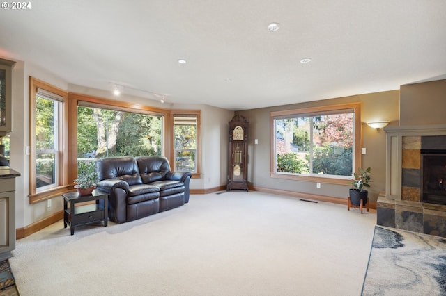 carpeted living room featuring a fireplace