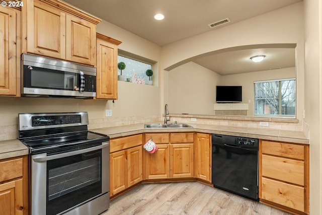 kitchen featuring light hardwood / wood-style floors, sink, stainless steel appliances, and light brown cabinetry