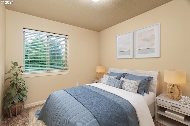 bedroom with carpet and a textured ceiling