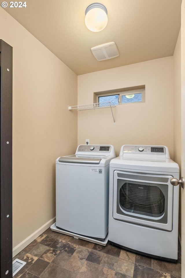 clothes washing area featuring independent washer and dryer