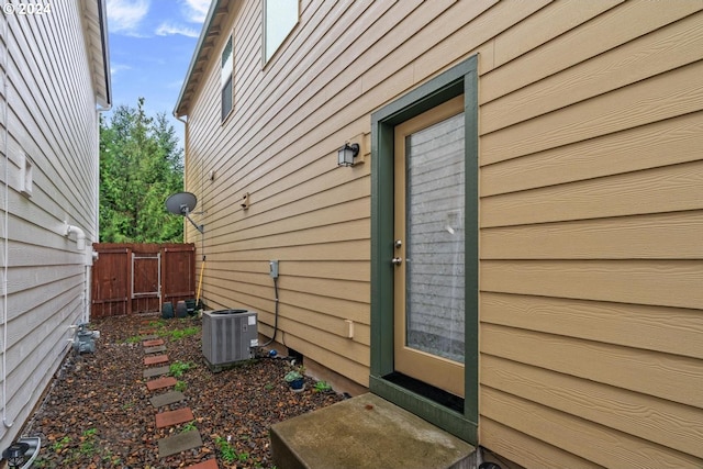 view of side of property featuring central air condition unit