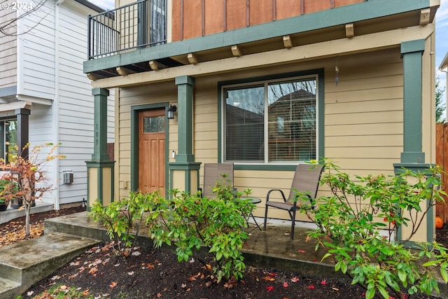 view of exterior entry featuring a balcony