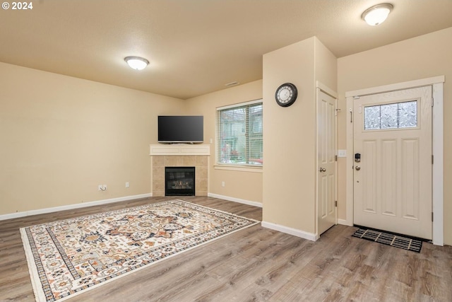 entryway featuring a fireplace and hardwood / wood-style floors