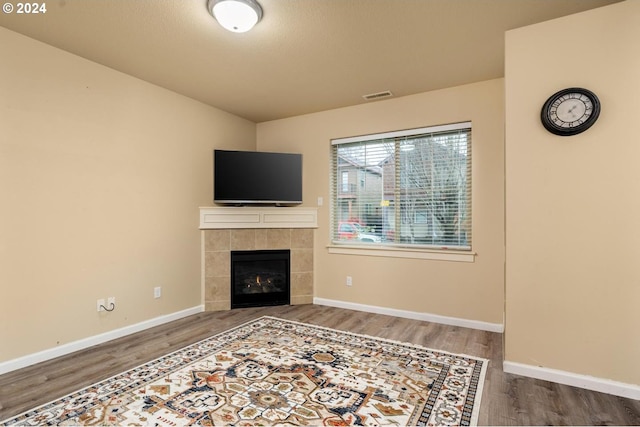 living room with hardwood / wood-style flooring and a fireplace