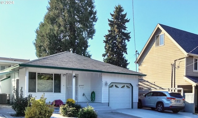 view of front of property with cooling unit and a garage