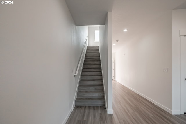 stairs with hardwood / wood-style floors