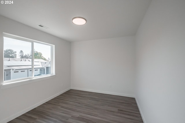 spare room with dark hardwood / wood-style flooring