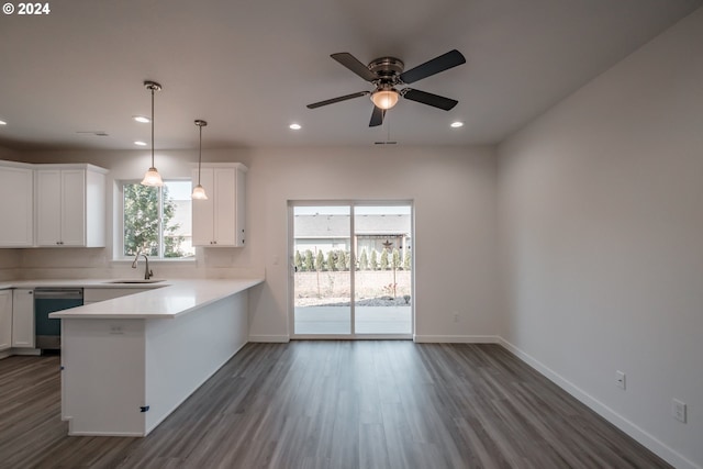 kitchen with white cabinetry, kitchen peninsula, and a healthy amount of sunlight