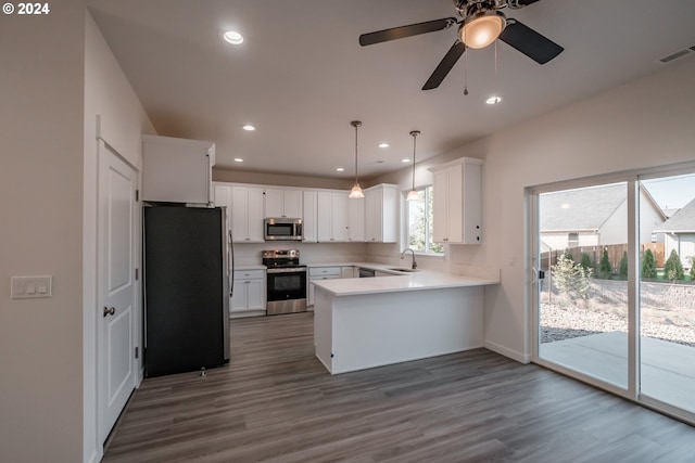 kitchen featuring kitchen peninsula, appliances with stainless steel finishes, ceiling fan, pendant lighting, and white cabinetry