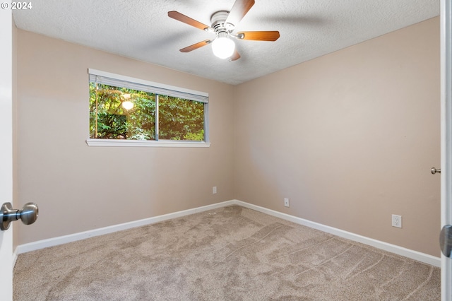 unfurnished room with light carpet, ceiling fan, and a textured ceiling