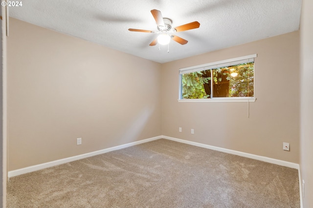 empty room with carpet, a textured ceiling, and ceiling fan