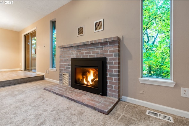 interior details with carpet, a fireplace, and a textured ceiling