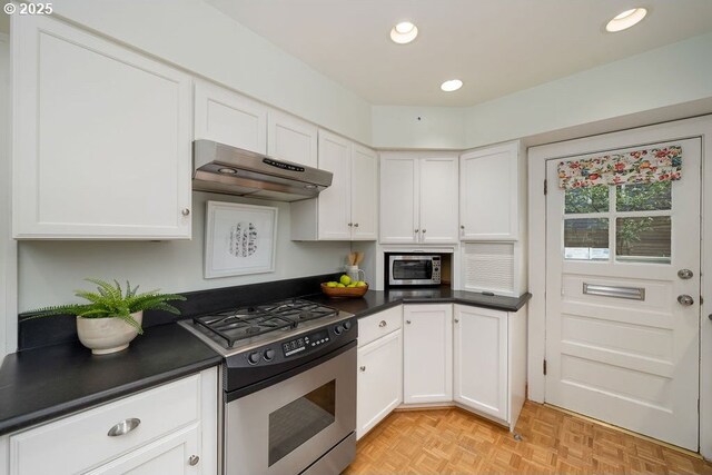 kitchen featuring sink, stainless steel appliances, white cabinets, and light parquet floors