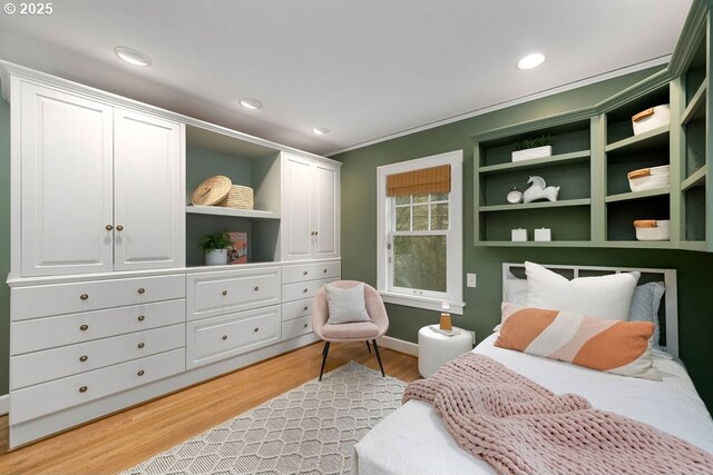 bedroom featuring light hardwood / wood-style flooring, multiple windows, and track lighting