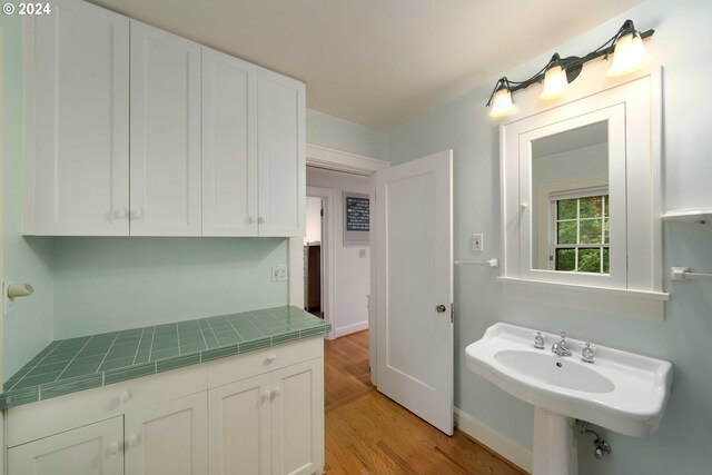 bathroom with hardwood / wood-style flooring and sink