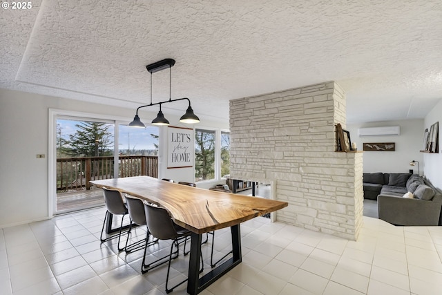 dining area featuring tile patterned floors, a textured ceiling, and a wall mounted AC