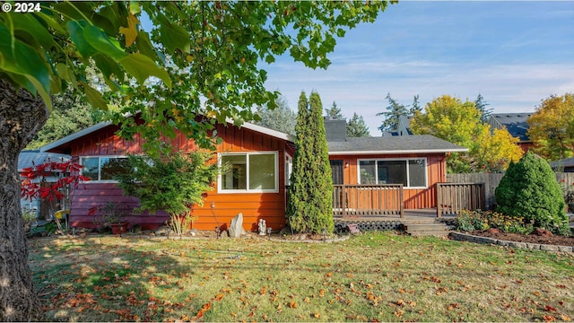 view of front of house with a front lawn and a deck