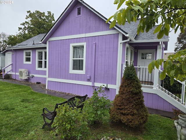 view of home's exterior featuring ac unit and a lawn