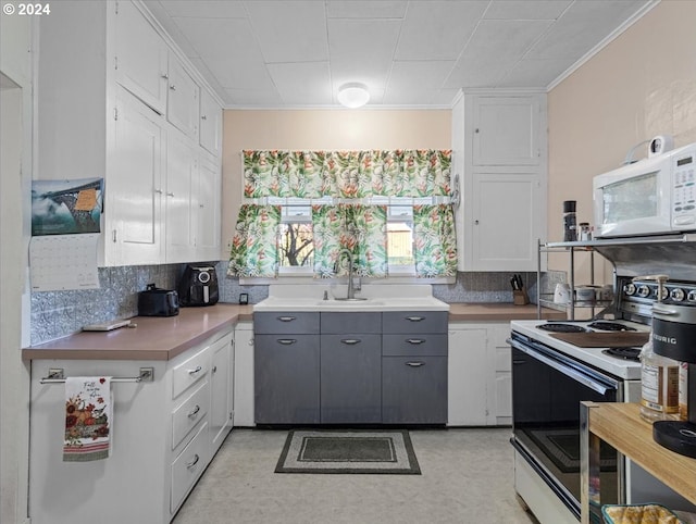 kitchen featuring white cabinets, white appliances, backsplash, gray cabinets, and crown molding