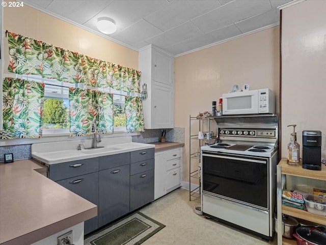 kitchen featuring sink, white appliances, white cabinetry, and crown molding