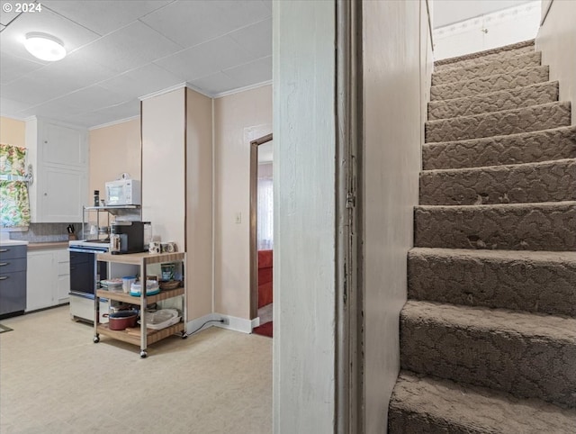 stairway featuring crown molding