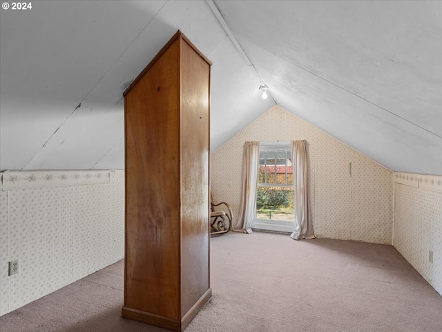 bonus room featuring light carpet and lofted ceiling