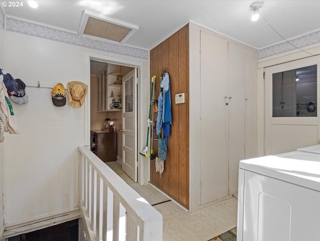 interior space featuring wood walls and washing machine and dryer