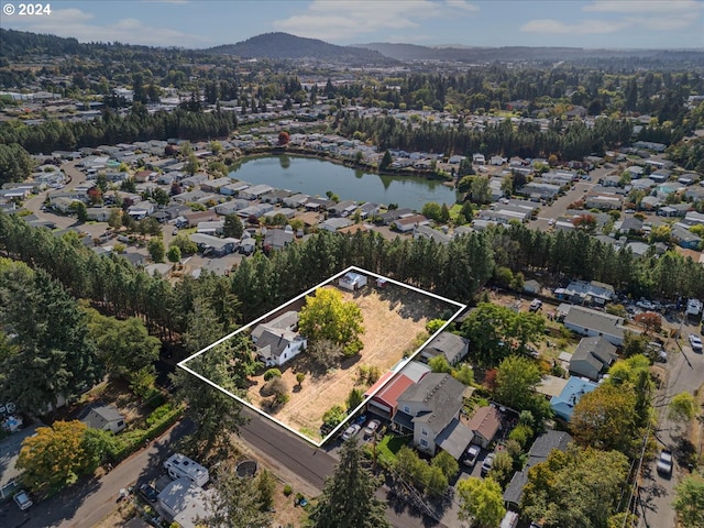 drone / aerial view with a water and mountain view