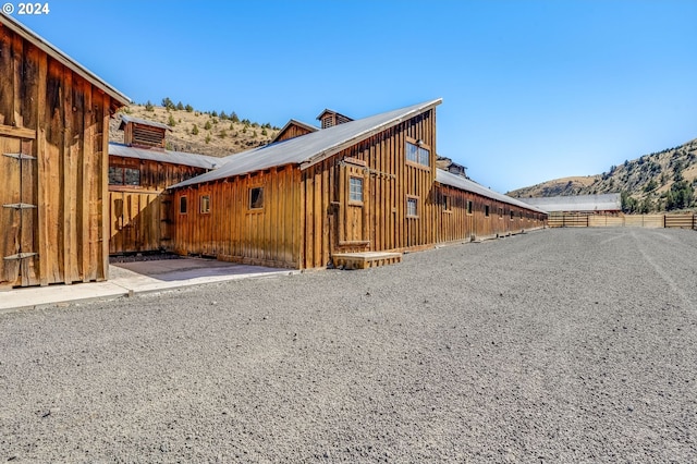 view of property exterior with a mountain view